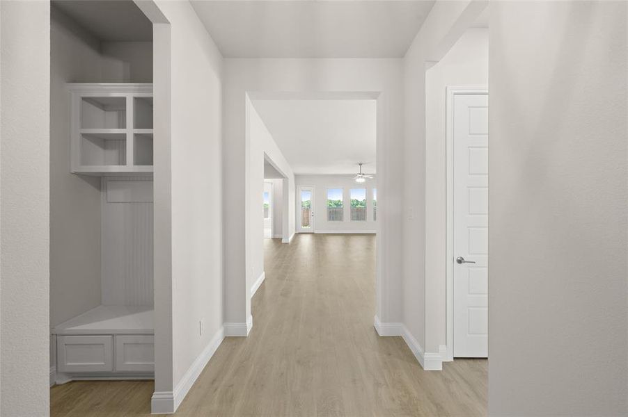 Corridor featuring light wood-style floors and baseboards