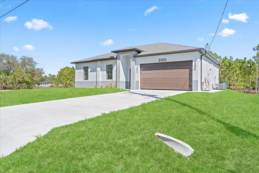 Front exterior of a new home in , Lehigh Acres, FL, highlighting curb appeal (Image 7).