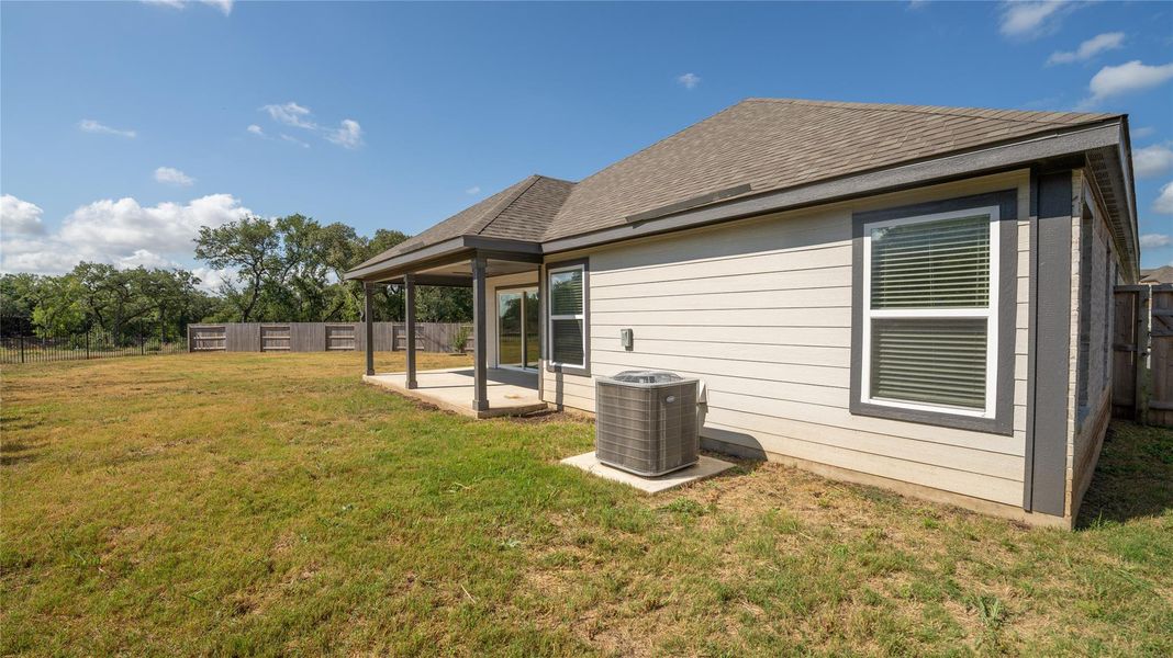Back of house featuring a fenced backyard, a patio, and roof with shingles Back of house featuring a fenced backyard, a patio, and roof with shingles