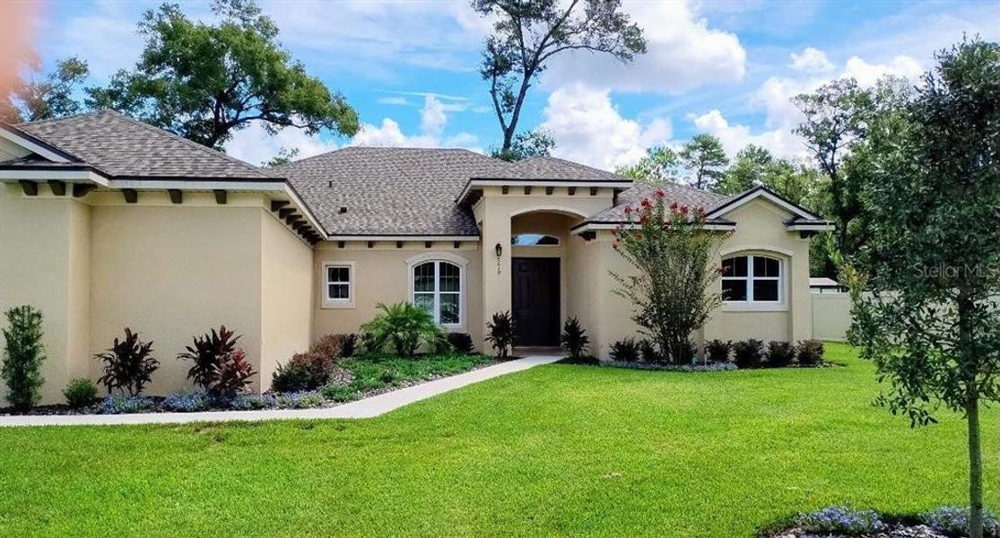 Front exterior of a new home in , Orange City, FL, highlighting curb appeal (Image 1).
