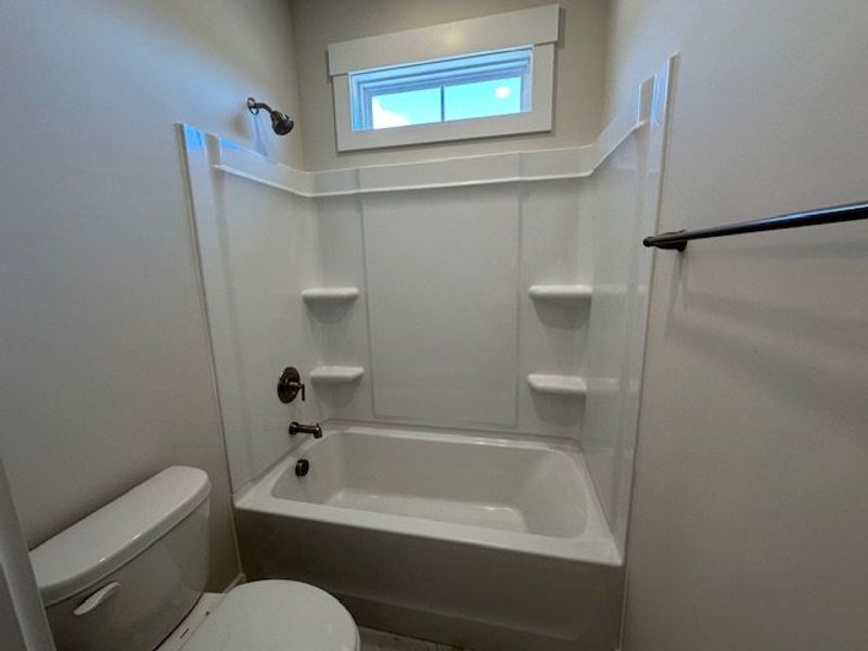 This bathroom offers a clean tub and shower combin