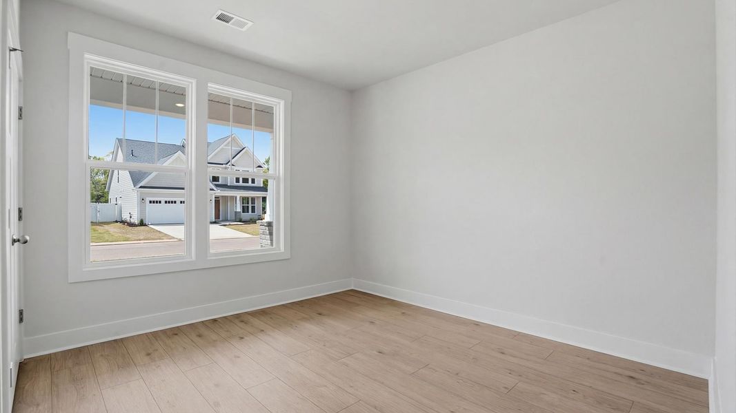 Functional secondary bedroom with hardwood flooring and modern touches in an exceptional layout at Pelham Crossing