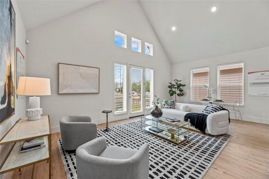 Warm inviting living room with soaring ceilings, flooded with natural light, and direct access to a private balcony—perfect for relaxing or entertaining.