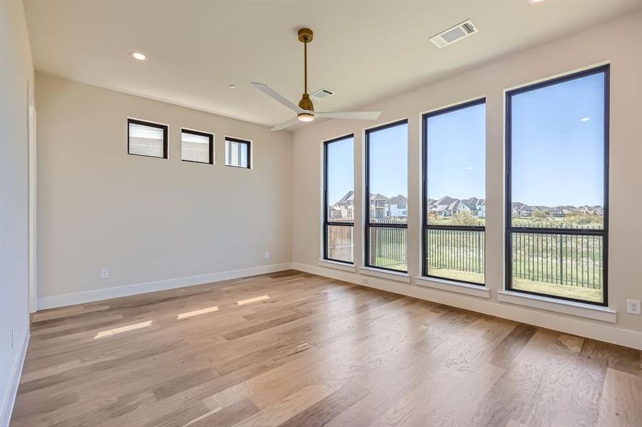 Unfurnished room featuring light wood-type flooring and ceiling fan