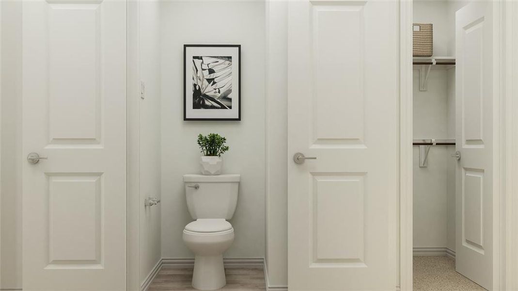 Bathroom with hardwood / wood-style floors and toilet