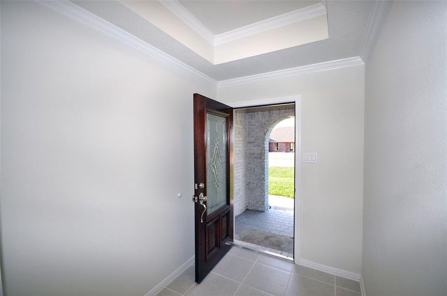 Enter into an elegant foyer through an etched glass mahogany door.