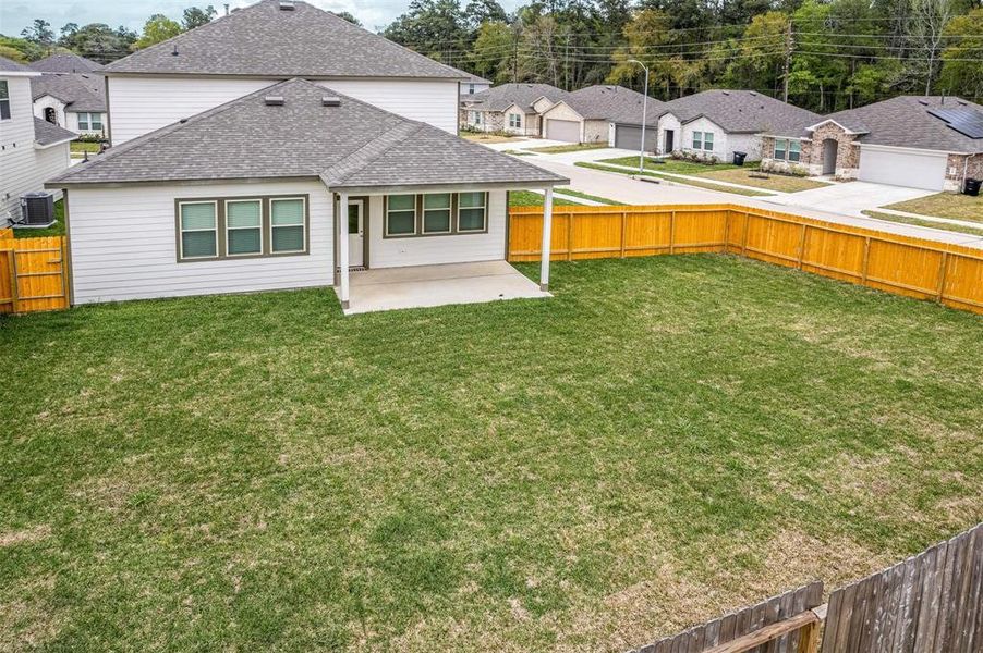 The expansive backyard offers plenty of space for outdoor activities, gardening, or future landscaping projects. The fenced perimeter ensures privacy and security, while the well-maintained lawn provides a beautiful and functional outdoor retreat for family and friends. Photos are from another Rylan floor plan.