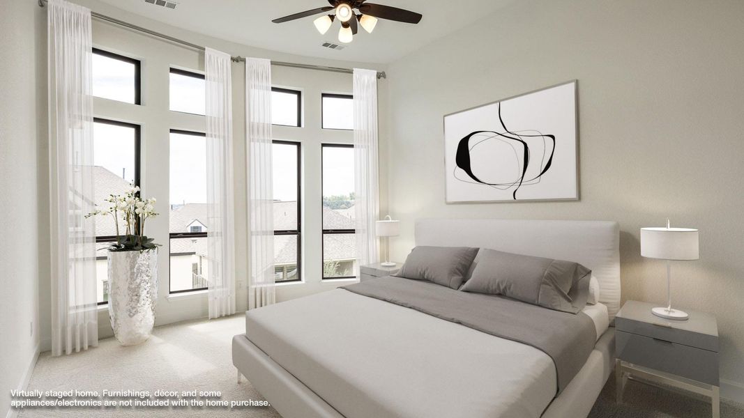Carpeted bedroom featuring a ceiling fan