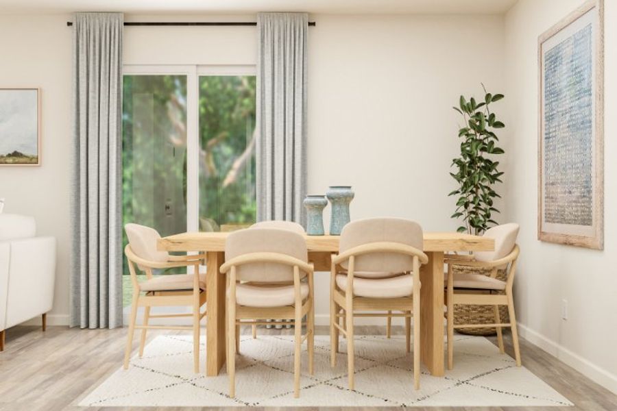 A dining room table with chairs around it.