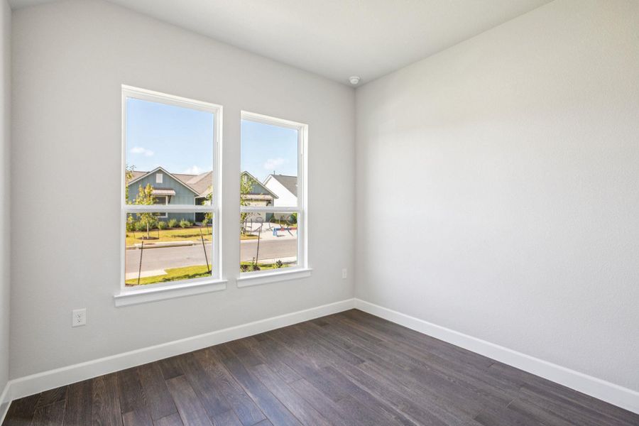 Unfurnished room featuring dark wood finished floors and baseboards Unfurnished room featuring dark wood finished floors and baseboards