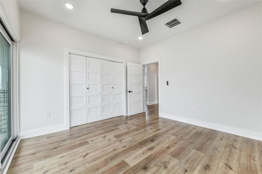 This bedroom feels like a private retreat, with direct balcony access overlooking the bay. New construction design, elevated ceilings, and endless water views make every morning feel like a getaway.