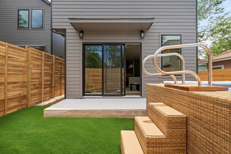A private backyard oasis awaits with artificial turf and a patio featuring direct access to the interior.