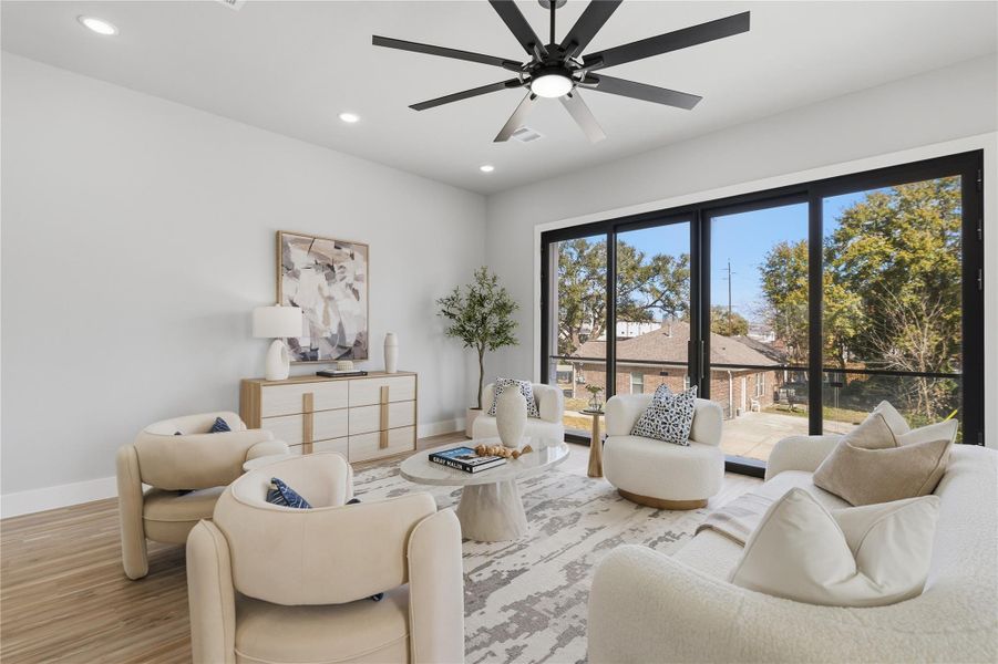 Light-filled living room with oversized sliding glass doors opening to the balcony.Indoor-outdoor flow, modern ceiling fan, and an airy layout made for relaxing or entertaining.