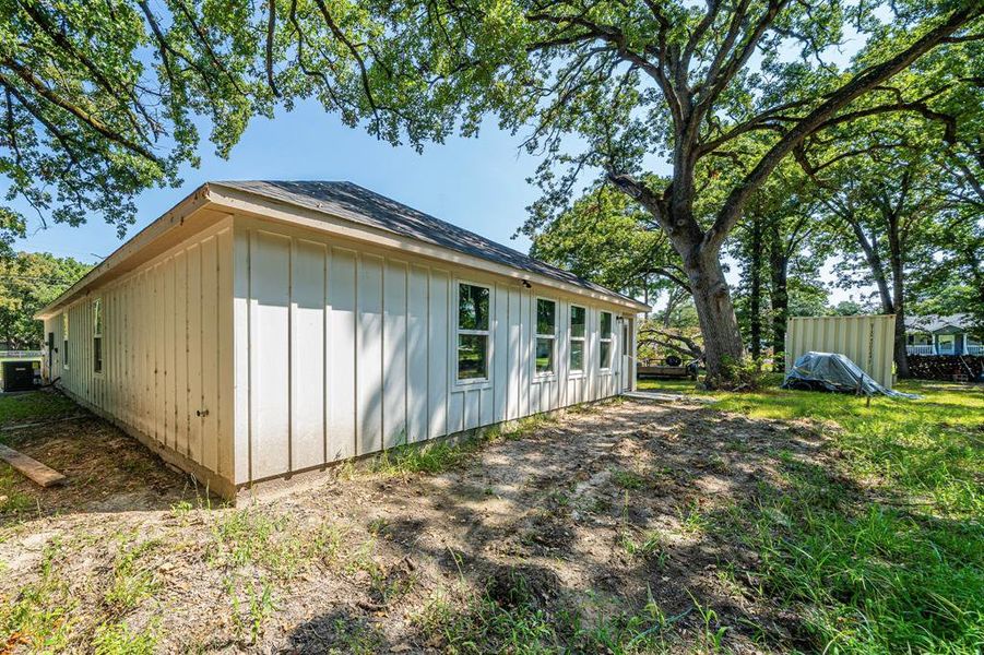 View of property exterior with board and batten siding and a central AC unit View of property exterior with board and batten siding and a central AC unit