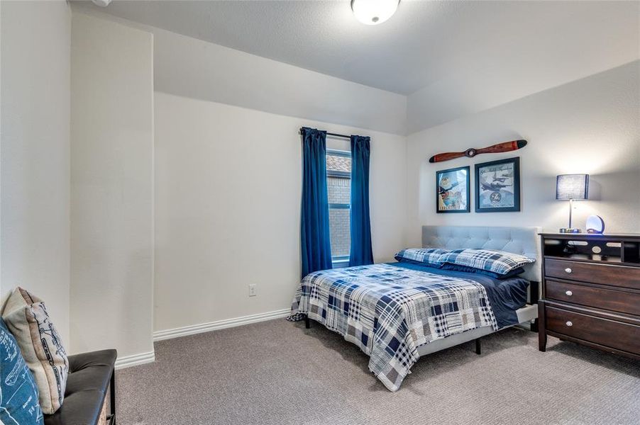 Carpeted bedroom featuring baseboards