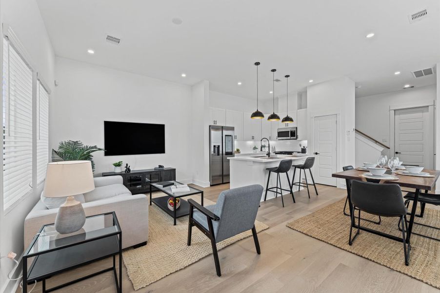 This inviting home features a spacious open-concept layout on the first floor, seamlessly connecting the living, dining, and kitchen areas to create a warm and functional gathering space. Large windows and glass door direct access to the front yard flooding the interior with natural light and extending the living space outdoors, perfect for entertaining or relaxing in the fresh air. The thoughtful design balances comfort and flow, making everyday living feel effortlessly connected to nature.