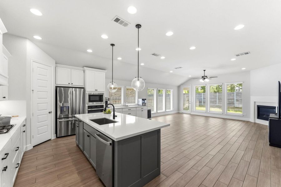 REFRIGERATOR INCLUDED! Open Concept Living, Quartz Island Kitchen and Wood Look Tile Throughout REFRIGERATOR INCLUDED! Open Concept Living, Quartz Island Kitchen and Wood Look Tile Throughout