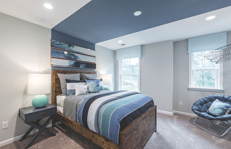 A large secondary bedroom with blue wall accent detail