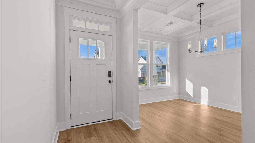 Vibrant entry highlighted by hardwood floors and accomplished design choices Vibrant entry highlighted by hardwood floors and accomplished design choices