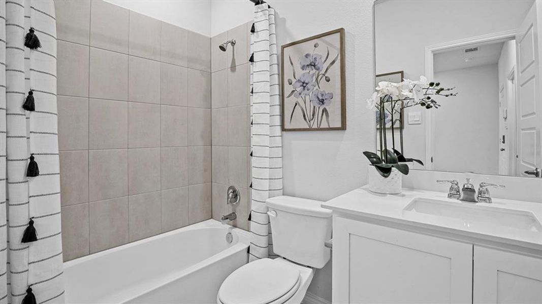 Full bath with vanity and shower / tub combo with curtain