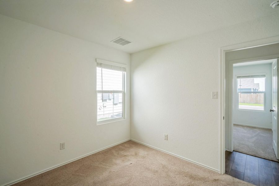 A well-lit room offers comfort with carpeted floors and a clean, neutral palette. A well-lit room offers comfort with carpeted floors and a clean, neutral palette.