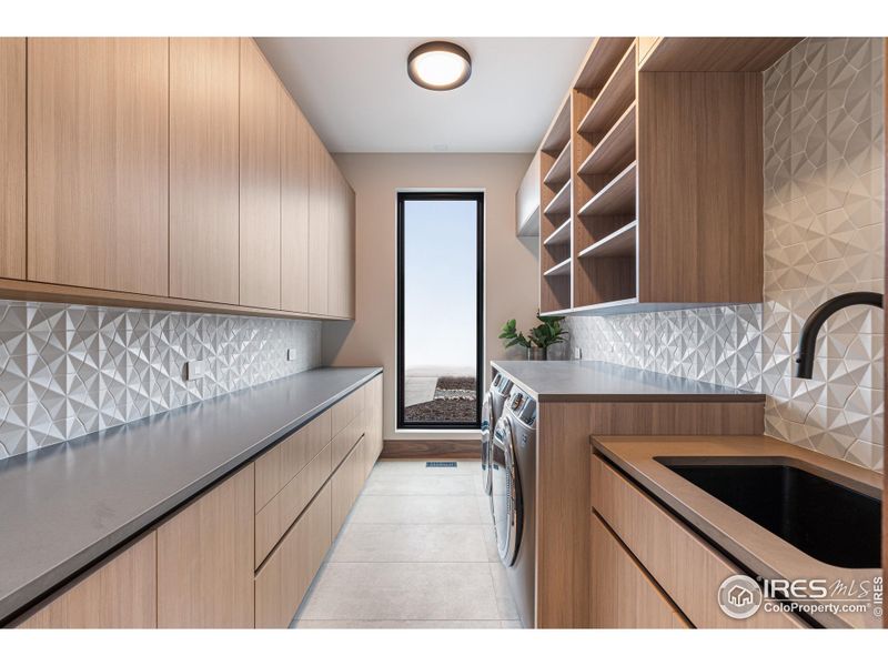 Two laundry rooms, one on each level. Providing abundant Shiloh Cabinetry & Pental Quartz folding counters. Upper level laundry provides 2 separate stackable washer/dryers. Blanco Anthracite Sink Basin, California Corsano Pull Down Faucets & GE Appliances