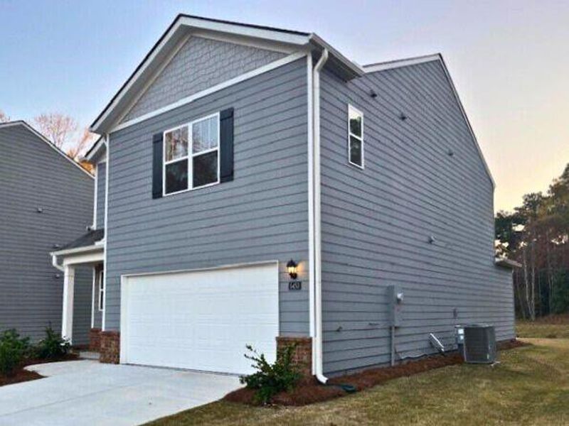 Front exterior of a new home in Sherwood Manor, College Park, GA, highlighting curb appeal (Image 1).
