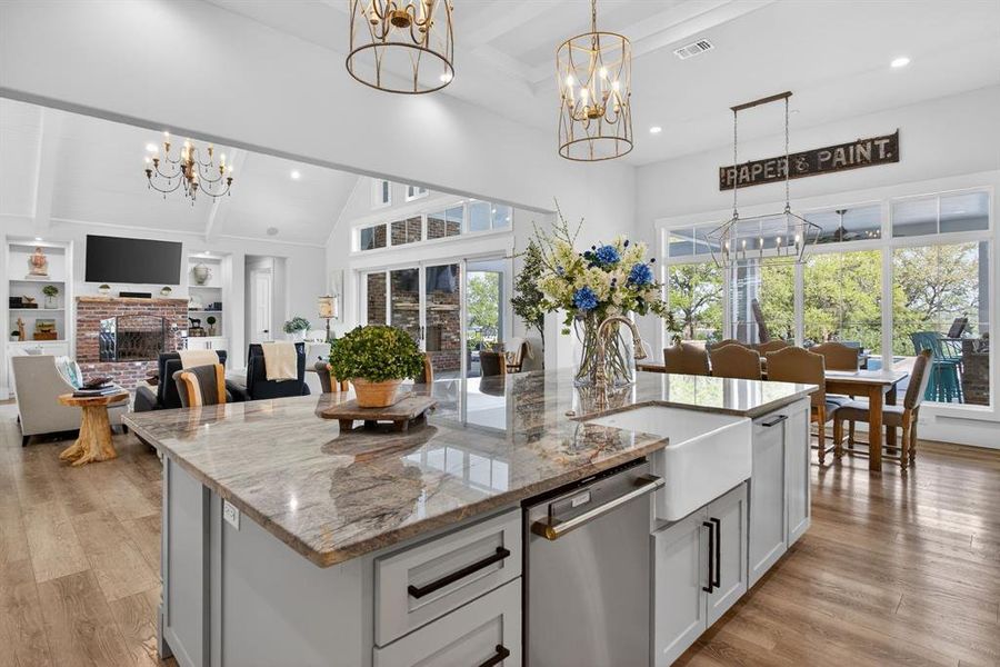 The gourmet kitchen boasts a large, farmhouse sink, an antique English fireback as the eye-catching and unique designer touch over the cooktop.