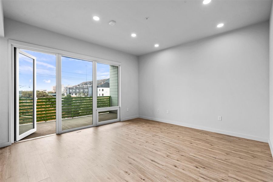 Empty room featuring wood finished floors, recessed lighting, and baseboards