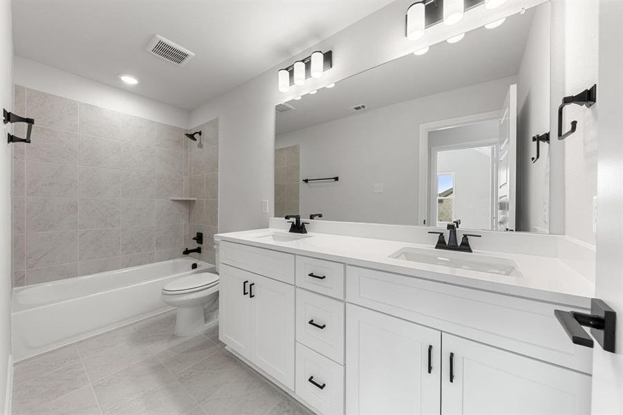 Guests will enjoy their own vanity space in this thoughtfully designed guest bath. Guests will enjoy their own vanity space in this thoughtfully designed guest bath.
