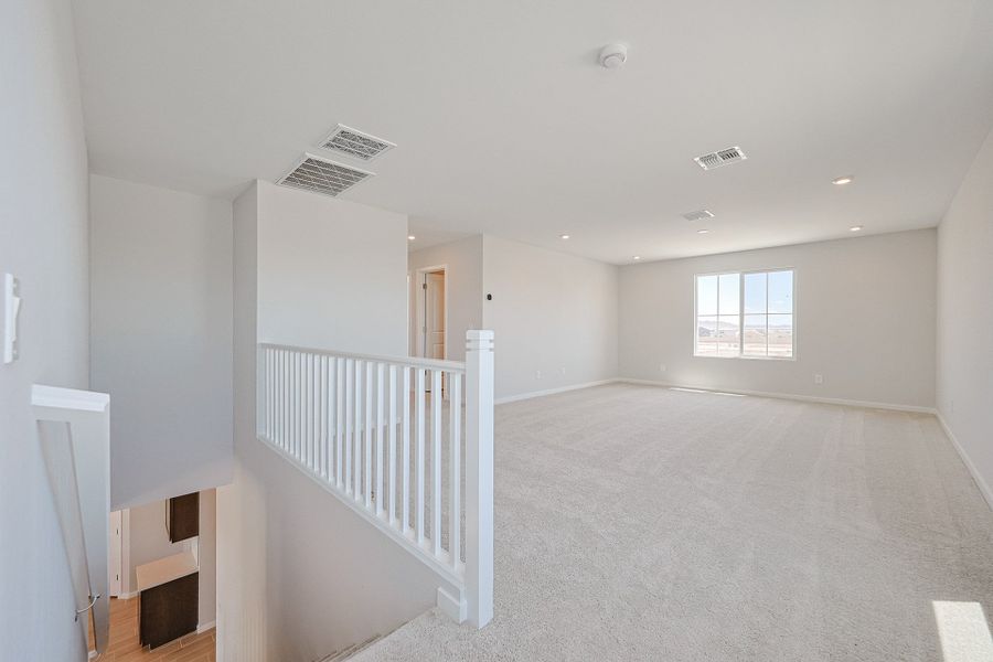 A room with a white railing and a white railing. A room with a white railing and a white railing.