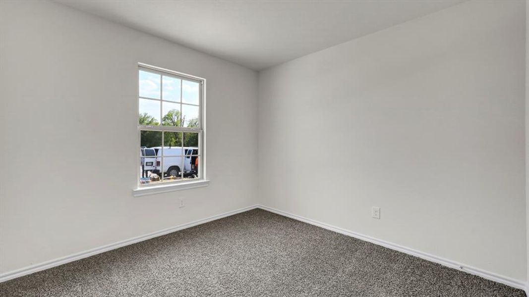 Neutral-toned interior with light gray walls, white baseboards, and textured gray carpet