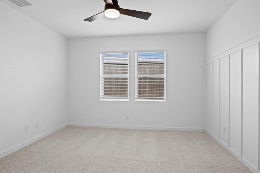 Spacious primary suite with feature wall