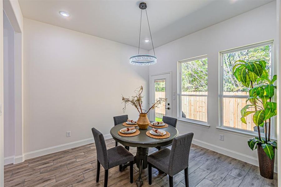 Dining area featuring light wood-style floors and recessed lighting