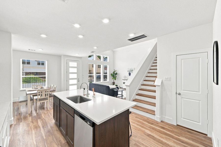 Open-concept kitchen with a large quartz island, seamlessly connecting the kitchen, breakfast area, and living space. Open-concept kitchen with a large quartz island, seamlessly connecting the kitchen, breakfast area, and living space.