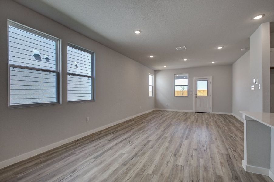 A room with a wood floor and white walls.