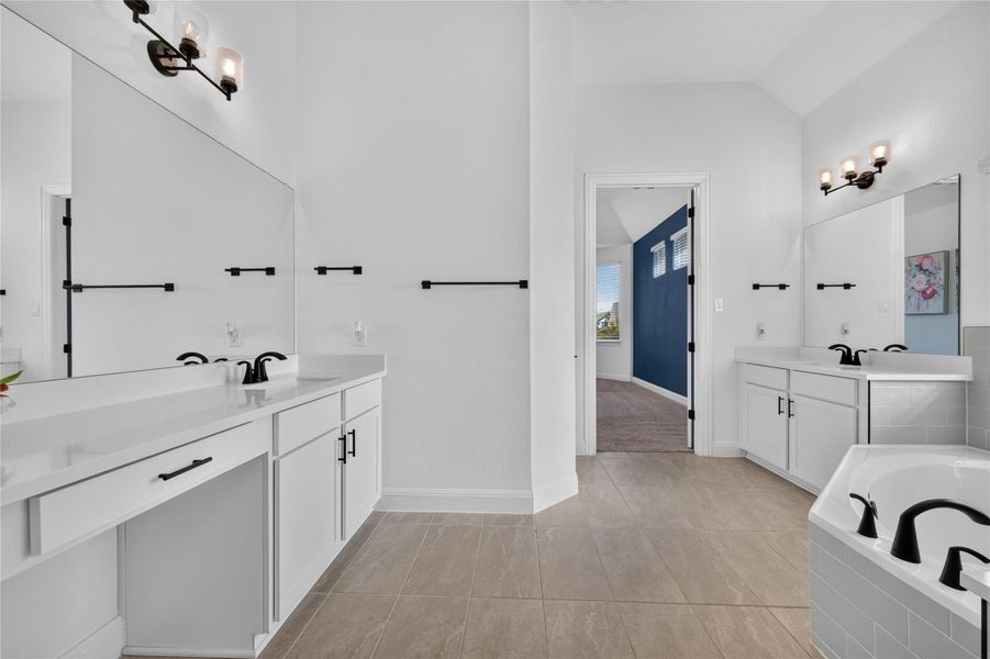 Clean lines and neutral tile flooring define this spacious bathroom featuring dual separate vanities. Clean lines and neutral tile flooring define this spacious bathroom featuring dual separate vanities.