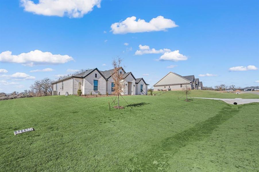 Front exterior of a new home in Rocky Top Ranch, Reno, TX, highlighting curb appeal (Image 20).