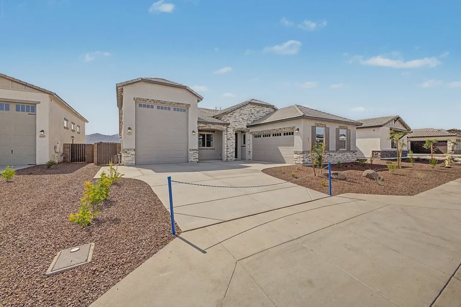 Front exterior of a new home in Valencia at Granite Vista, Waddell, AZ, highlighting curb appeal (Image 1). Front exterior of a new home in Valencia at Granite Vista, Waddell, AZ, highlighting curb appeal (Image 1).