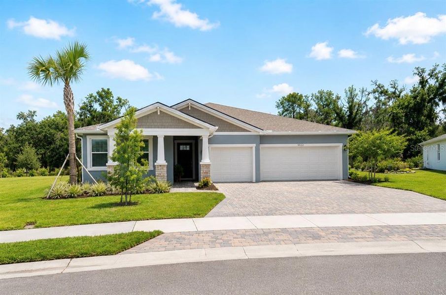 Front exterior of a new home in Windwater, Parrish, FL, highlighting curb appeal (Image 2). Front exterior of a new home in Windwater, Parrish, FL, highlighting curb appeal (Image 2).
