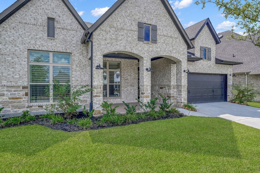 Front exterior of a new home in The Meadows at Imperial Oaks, Conroe, TX, highlighting curb appeal (Image 16). Front exterior of a new home in The Meadows at Imperial Oaks, Conroe, TX, highlighting curb appeal (Image 16).