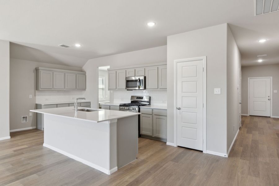 Kitchen in the Harrison home plan by Trophy Signature Homes – REPRESENTATIVE PHOTO