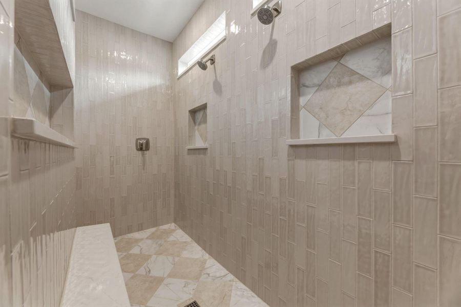 Large walk-in shower, 2 entrances, multiple shower heads, fully tiled, and feels like pure elegance.