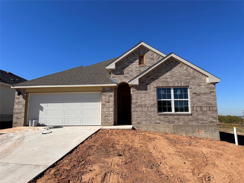 View of front facade featuring concrete driveway, an attached garage, and brick siding View of front facade featuring concrete driveway, an attached garage, and brick siding