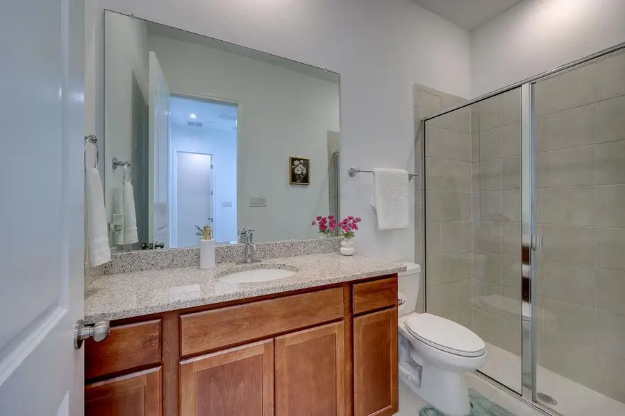 Full bath featuring vanity and a shower stall