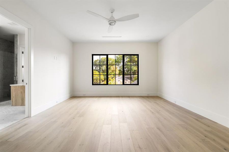 Unfurnished room featuring light wood-style floors and a ceiling fan Unfurnished room featuring light wood-style floors and a ceiling fan
