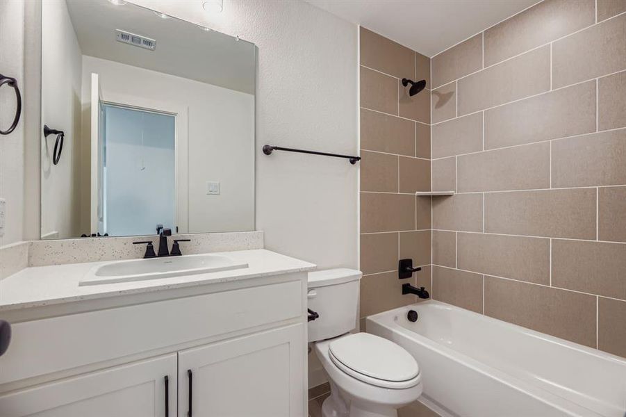 Bathroom featuring shower / washtub combination and vanity Bathroom featuring shower / washtub combination and vanity