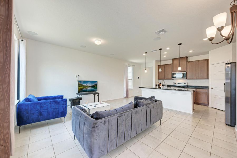 An open concept living area transitions seamlessly into a well-appointed kitchen.