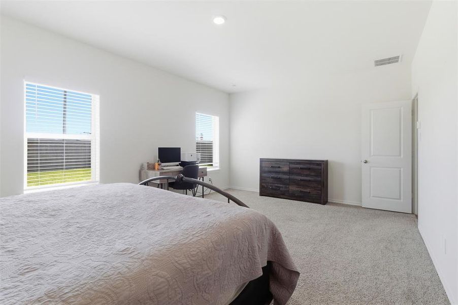 Carpeted bedroom with a desk and recessed lighting Carpeted bedroom with a desk and recessed lighting