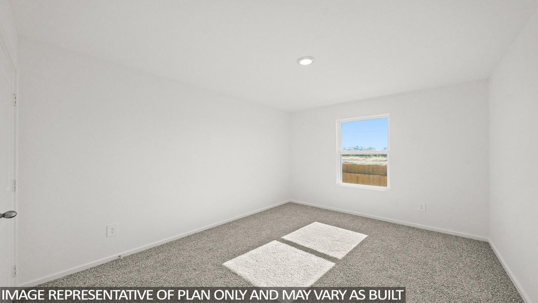 Sun-drenched, naturally lit bedroom with comfortable carpet flooring. Sun-drenched, naturally lit bedroom with comfortable carpet flooring.